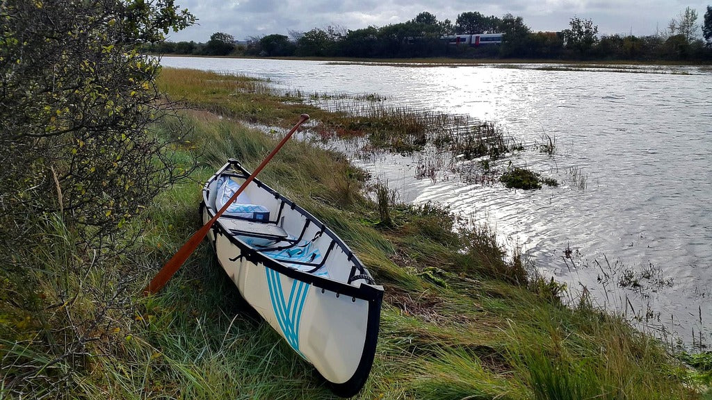 mycanoe duo 2-person folding canoe beached on river bank