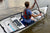 Man in life jacket paddles his MyCanoe foldable canoe in a lake