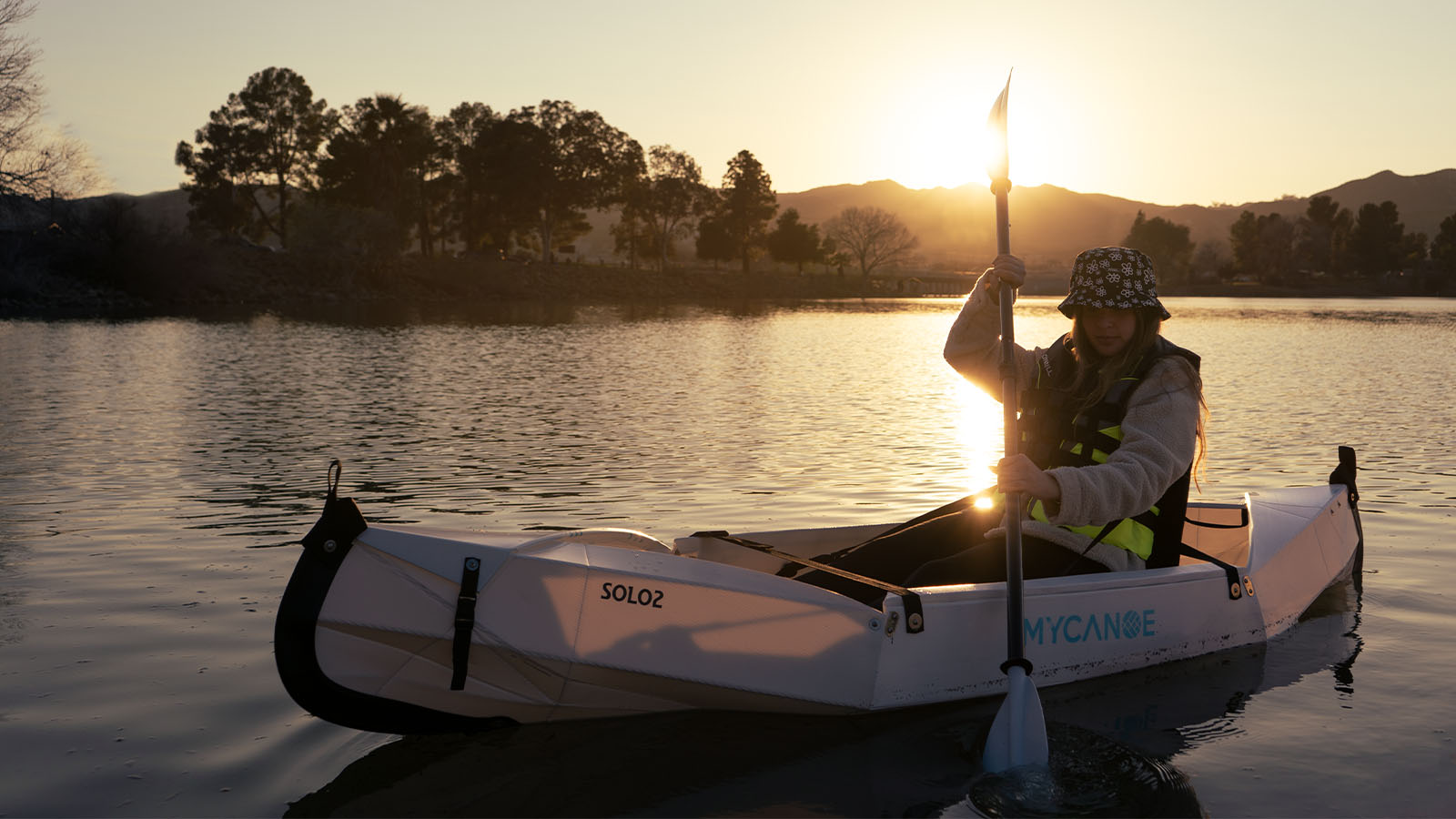woman rowing her MyCanoe solo 2 origami canoe in the sunset