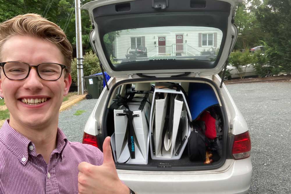 Man puts his MyCanoe foldable boat in the back of his car